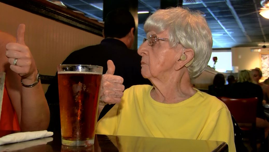 Millie Bowers, who turned 103 recently, gives a thumbs up after having a beer. (Source: Live 5)